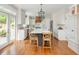 Bright, airy kitchen with white cabinets, stainless appliances, and an expansive island with seating at 7048 Bennington Ln, Cumming, GA 30041