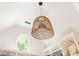 Unique lighting fixture with a round window and high ceiling in a walk-in closet with custom shelving at 7048 Bennington Ln, Cumming, GA 30041