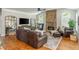 Open living room with stone fireplace, large windows, and comfortable seating creating an inviting atmosphere at 7048 Bennington Ln, Cumming, GA 30041