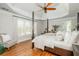 Spacious main bedroom featuring a tray ceiling, hardwood floors, and large windows with plantation shutters at 7048 Bennington Ln, Cumming, GA 30041