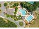 Aerial view of a community pool area, featuring multiple pools, a slide, and ample seating at 7048 Bennington Ln, Cumming, GA 30041