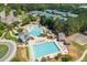 Aerial view of a community swimming pool and sport courts surrounded by trees at 7048 Bennington Ln, Cumming, GA 30041