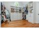 Spacious walk-in closet featuring custom shelving, drawers, and ample storage space with a large mirror and wooden floors at 7048 Bennington Ln, Cumming, GA 30041