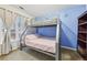 Charming bedroom with bunk beds, blue accent wall, and ample natural light at 1031 Bettina Sw Ct, Mableton, GA 30126