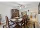 Traditional dining room featuring a large dining table with seating for eight and china cabinet at 1031 Bettina Sw Ct, Mableton, GA 30126