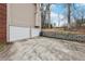 Long driveway leading to a two-car garage, complemented by a landscaped yard at 1031 Bettina Sw Ct, Mableton, GA 30126