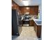Functional kitchen with stainless steel appliances, light countertops, and dark wood cabinetry at 1031 Bettina Sw Ct, Mableton, GA 30126