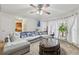 Open living room with a large sectional sofa, coffee table, and views to the kitchen at 1031 Bettina Sw Ct, Mableton, GA 30126