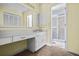 Bathroom with white vanity, large mirror, and access to a shower with sliding doors at 1229 Colony Cir, Marietta, GA 30068