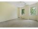 Bedroom featuring two windows, carpeted floor, and natural light at 1229 Colony Cir, Marietta, GA 30068