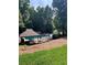 Community pool area with lounge chairs and picnic area surrounded by mature trees at 1229 Colony Cir, Marietta, GA 30068