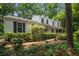Charming home with a covered porch, beautiful landscaping, and mature trees offering curb appeal at 1229 Colony Cir, Marietta, GA 30068