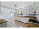 Bright kitchen with white cabinets, tile flooring, and ample counter space overlooking the eating area at 1229 Colony Cir, Marietta, GA 30068