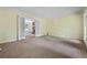 Spacious living room with neutral carpeting, large windows, and access to an adjacent room via French doors at 1229 Colony Cir, Marietta, GA 30068