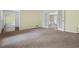 Spacious living area with neutral carpeting, connecting to another room through elegant doors at 1229 Colony Cir, Marietta, GA 30068