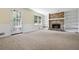 Inviting living room featuring a brick fireplace, built-in bookshelves, and a door leading outside at 1229 Colony Cir, Marietta, GA 30068