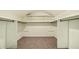 Large walk-in closet featuring carpeted floors and multiple shelves for organization at 1229 Colony Cir, Marietta, GA 30068
