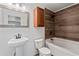 Modern bathroom with wood-look shower, pedestal sink, and decorative mirror at 2265 Venture Dr, Marietta, GA 30062