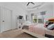 Well-lit bedroom with a white bed frame, pink accents, and large window at 2265 Venture Dr, Marietta, GA 30062