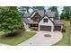 Beautiful home with stone and shingle details, a large driveway, and mature trees at 2265 Venture Dr, Marietta, GA 30062