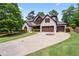 Lovely front exterior of a two story house with a big driveway and a lush lawn at 2265 Venture Dr, Marietta, GA 30062