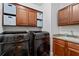 Efficient laundry room with modern washer and dryer, granite countertop, cabinets, and storage for supplies at 2265 Venture Dr, Marietta, GA 30062