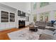 Bright living room boasts a fireplace, built-in shelves, large windows, and a comfortable sectional at 2265 Venture Dr, Marietta, GA 30062