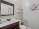 Stylish powder room featuring modern fixtures, decorative shelves, and elegant wallpaper at 2265 Venture Dr, Marietta, GA 30062