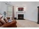 Sitting area with leather sofa, fireplace, TV, and plenty of natural light at 2265 Venture Dr, Marietta, GA 30062