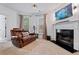 Sitting area with leather sofa, fireplace, TV, and plenty of natural light at 2265 Venture Dr, Marietta, GA 30062