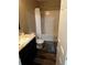 Bathroom features wood-look floors, a shower/tub combo, and dark vanity at 314 Meadows Ln, Canton, GA 30114