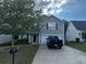 Two-story home with a driveway and a black truck parked in front of the garage at 314 Meadows Ln, Canton, GA 30114