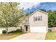 Charming two-story home with a well-manicured lawn, attached garage, and inviting front entry at 314 Meadows Ln, Canton, GA 30114