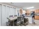 Open kitchen area with stainless appliances, bar seating, and dining table with modern chairs at 314 Meadows Ln, Canton, GA 30114