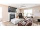 Cozy living room featuring a fireplace, ceiling fan, and comfortable leather seating at 314 Meadows Ln, Canton, GA 30114