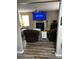 Living room showcases fireplace, TV, leather furniture, and ceiling fan at 314 Meadows Ln, Canton, GA 30114