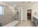 Modern bathroom with a glass-enclosed shower, tiled walls, and a view into a closet at 4724 Electric Sw Ave, Mableton, GA 30126