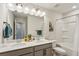 Bathroom featuring dual sinks, modern lighting and bath/shower combo at 4724 Electric Sw Ave, Mableton, GA 30126