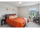 Inviting bedroom features an orange bed and lots of natural light at 4724 Electric Sw Ave, Mableton, GA 30126