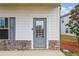 Close-up of the front door with stone detailing and manicured landscaping at 4724 Electric Sw Ave, Mableton, GA 30126
