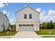 View of a home's two-car garage with grey doors on a sunny day at 4724 Electric Sw Ave, Mableton, GA 30126