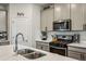 Close-up view of kitchen with stainless steel microwave and gas range oven at 4724 Electric Sw Ave, Mableton, GA 30126