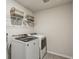 This laundry room has a washer and dryer and a wire rack for storage at 4724 Electric Sw Ave, Mableton, GA 30126