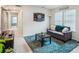 Cozy living room features a gray sofa, dartboard, and bright natural light at 4724 Electric Sw Ave, Mableton, GA 30126