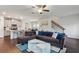Open-concept living room showcasing a large sofa, ceiling fan, and view into kitchen at 4724 Electric Sw Ave, Mableton, GA 30126