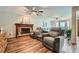 Cozy living room with a brick fireplace, wood floors, comfortable seating, and views from the back windows at 5170 Ridge Tarn, Acworth, GA 30102