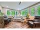 Relaxing sunroom with many windows providing views into the wooded backyard at 5170 Ridge Tarn, Acworth, GA 30102