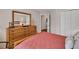 Comfortable bedroom featuring a plush bed, wood dresser, and ample closet space at 1720 Ivey Trce, Cumming, GA 30041