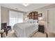 Bedroom featuring a neutral color scheme, bright lighting, and a comfortable bed with soft pillows at 1720 Ivey Trce, Cumming, GA 30041