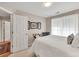 Bedroom featuring a neutral color scheme, bright lighting, and a comfortable bed at 1720 Ivey Trce, Cumming, GA 30041